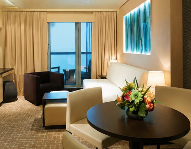 Living and dining space in the supplied Norwegian Gem Haven suite photo collection
